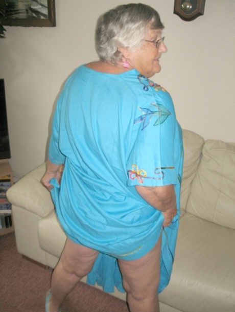 Taking off her panties and licking her naked navels, Grandma Libby is seen with her hands on the belly button.
