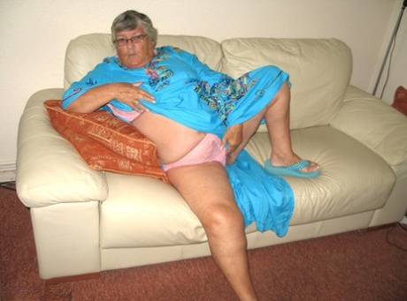 After removing her pink panties, Grandma Libby uses the bathroom to stroke her tummy.