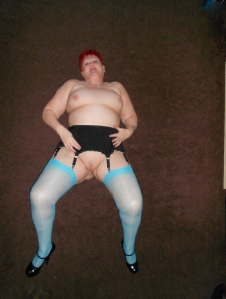 Older redhead Valgasmic models are exposed wearing blue nylons and garters to their bare legs.