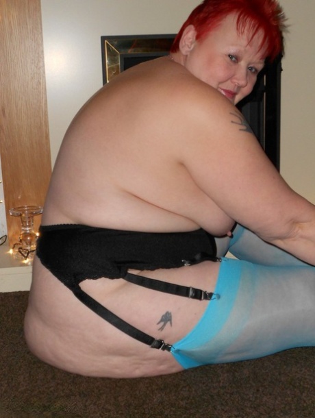 Older redheads, such as the Valgasmic, expose themselves in blue nylon and garter attire.