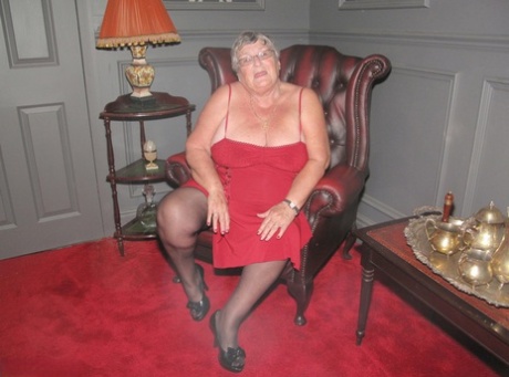 An old grandmother named Grandma Libby displays her bald pussy in stockings.