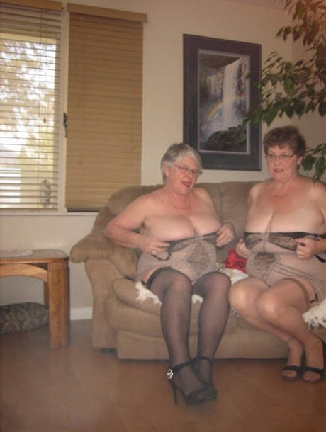 An amateur granny named Girdle Goddess and another Nanny model are dressed in matching nylon lingerie.