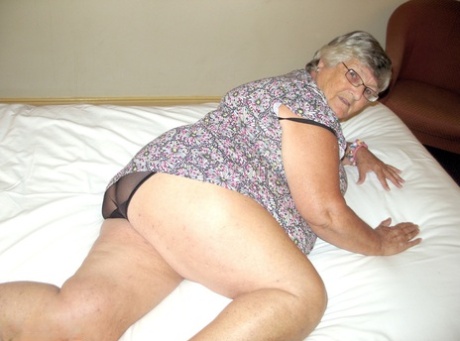 A bed is where Grandma Libby, an overweight woman with silver hair from Britain, exposes her fat body.