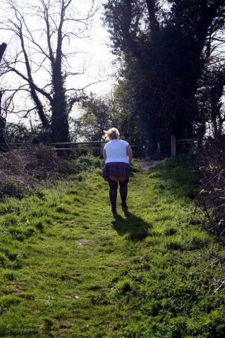 Lexie Cummings, a blonde who is overweight, exposes herself by means of her locks on a canal system.