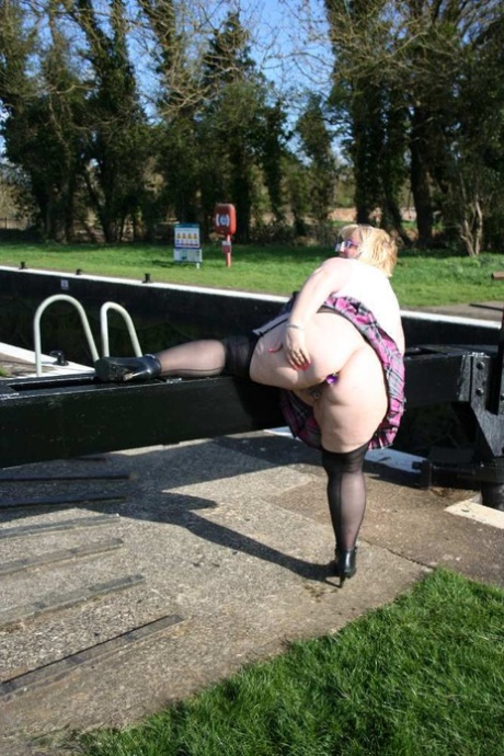 On a canal system, Lexie Cummings, a blonde who is overweight, exposes herself by sticking her hair out.