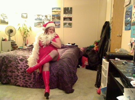 While wearing Xmas attire, Misha MILF, a young redhead, loosens her hair and performs oral sex on the chest.