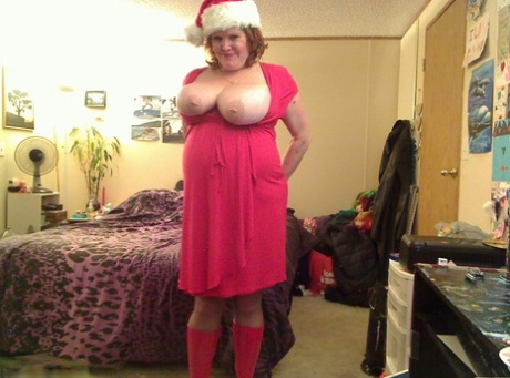 In the spirit of Christmas, Misha MILF is seen in Xmas clothing loosening up and performing her usual big fists.