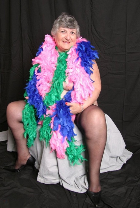 Fat UK amateur Grandma Libby drapes her big tits in feather boas.