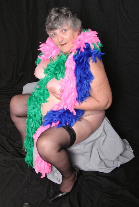 Big tits: Fat UK amateur Grandma Libby (left) poses with her big tits draped over her feather boas.