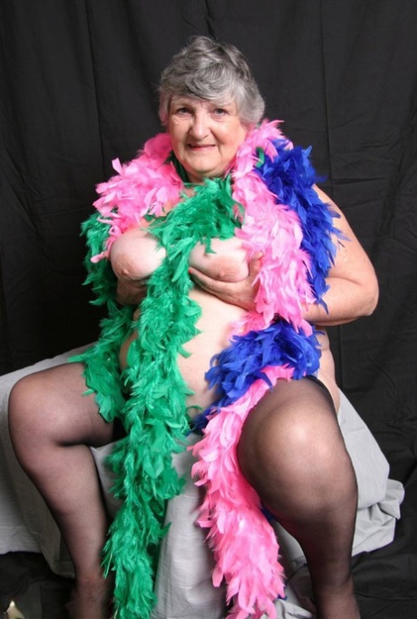 Big tits: UK amateur Grandma Libby, who is fat, shows off her feather boas.