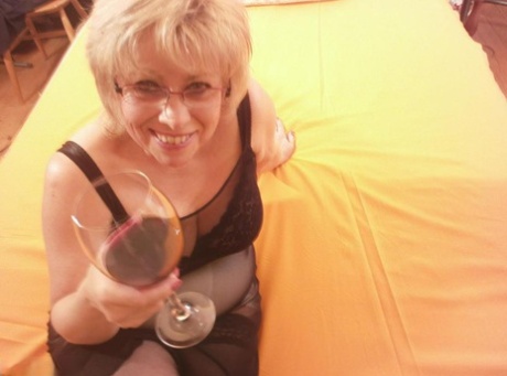 Tipsy hot granny Caro was seen lying on her bed with black stockings and spreading her legs.