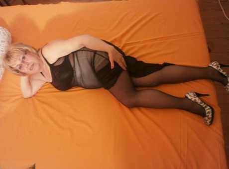 Granny Caro, the hottie with tipsy legs and black stockings, was spread out on her bed.