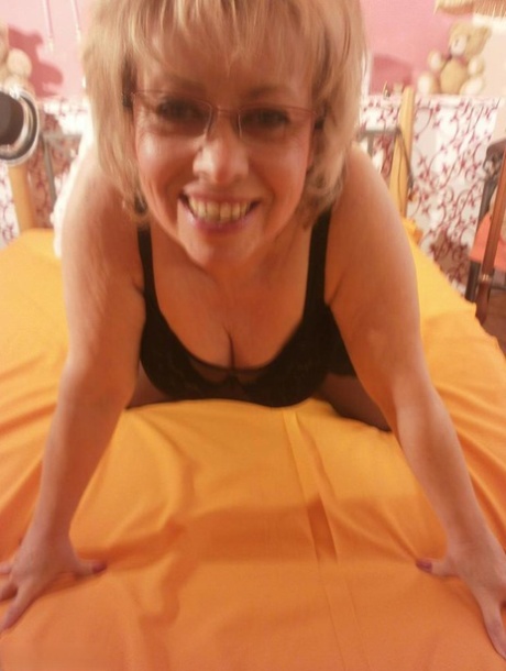 Hot granny Caro, who is tipsy and hot, was lying on her bedside wearing black stockings.