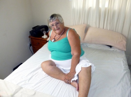 Fat Granny With Short Hair And A Huge Belly Sticks A Dildo In Her Pussy