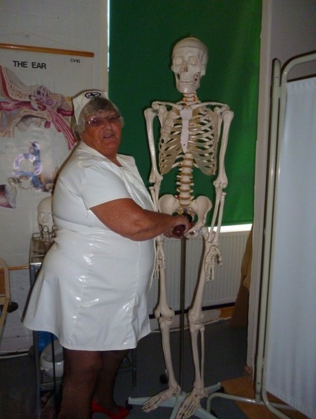 To ease her mind, Grandma Libby, a fat and elderly nurse, attaches a dildo to a skeleton.
