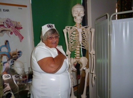 To provide her with a sense of relaxation, Grandma Libby, a fat and elderly nurse, attaches a dildo to a skeleton.