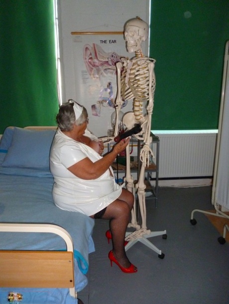 Fat old nurse Grandma Libby attaches a dildo to a skeleton for sexual relief