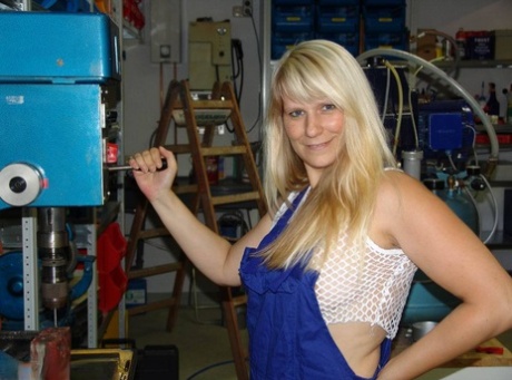 Prior to masturbating in the workshop, a mature blonde removes her overall and sleeps.