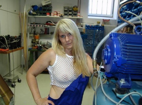 In the workshop, a mature blonde removes her overall and masturbates afterwards.