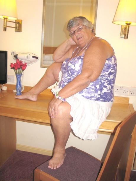 A hotel room is where Grandma Libby, an obese British woman, disrobes completely.