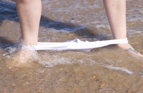 Mature amateur Speedy Bee gets naked in shades on a British beach