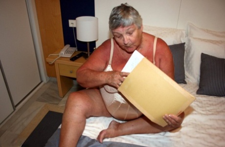 As she reads a girly magazine, Grandma Libby (a fat British lady) masturbates.