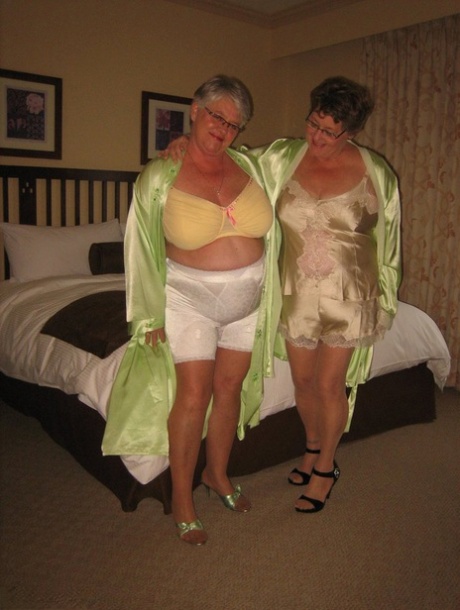 Her horny friend and the fat Girdle Goddess are seen having fun while stripping to stimulate their firm buttocks.