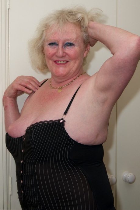 Blondy Claire Knight, who is now 80 years old, has a bald pussy and fondles her in stockings on a bed.