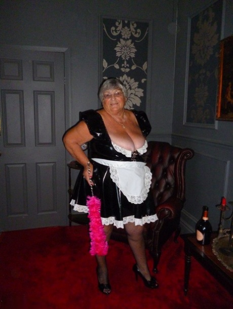 The fat maid, Grandma Libby, removes her uniform and takes off her stockings in the nude.