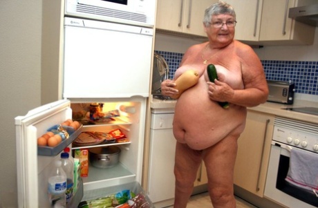 Exhausted: Grandma Libby (left), an obese British beauty, gets completely naked as she cleans her kitchen.