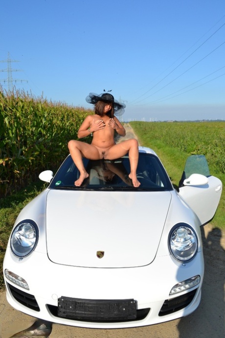 Asian Amateur Gets Naked On Top Of A Car While Wearing A Big Hat