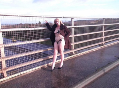 During an overpass, Barby Slut, an older performer, flashes on the sidewalk.