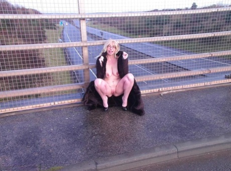 Old barby slut walks on a footpath when an overpass is crossed.