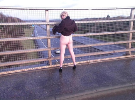A passerby spots Barby Slut, an older performer, flashing on a pavement while passing by.