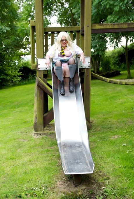 Old UK amateur Barby Slut exposes herself in schoolgirl attire on a playground.