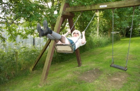 A UK amateur of some time, Barby Slut exposes herself in schoolgirl outfits on a playground.