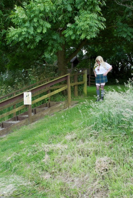 UK amateur barby Slut bares herself on the playground in schoolgirl gear.