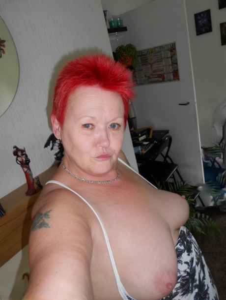 The Valgasmic Exposedabres, an older redhead, flaunts her tits and twats while taking selfies.