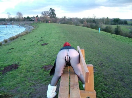 A park is where Redhead Valgasmic Exposed plays with a toy in an open-air area without a crotch.