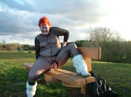 A toy is played with Redhead Valgasmic Exposed in a park, while wearing a non-slipped harness.