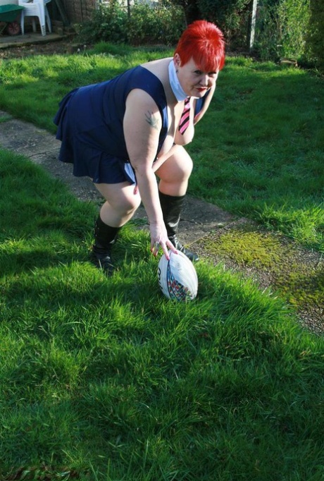 Valgasmic Exposed's overweight redhead flaunts her thighs while playing with a football.