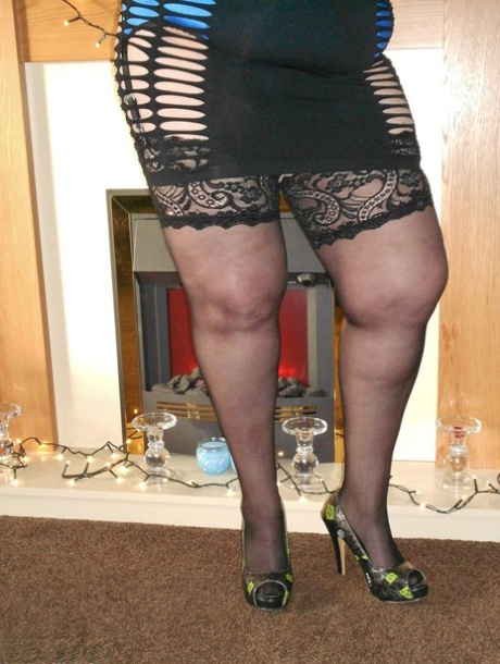 In heels, SSBBW models his seductive lingerie with large red lips and flirty looks.