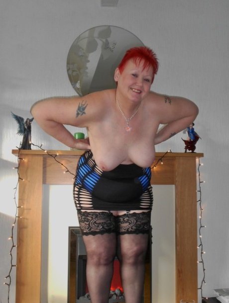Flamboyant redhead SSBBW bares huge big tits to model sexy lingerie in heels