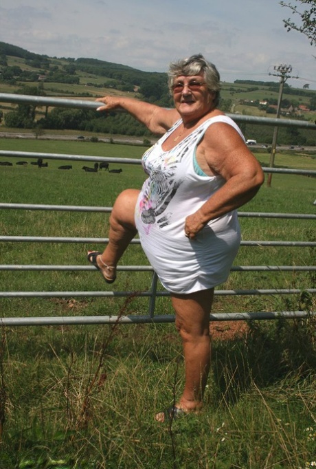 In front of an old British woman, Grandma Libby exposes herself in close proximity to a field of cattle.