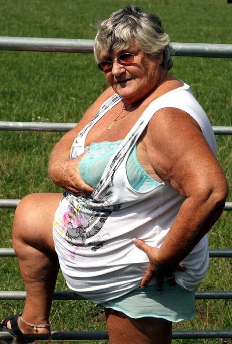 An old British woman known as Grandma Libby takes on the role of being next to a field of cattle.