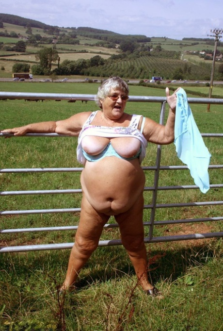 Exposed: Grandma Libby, an old British woman looks out over a field of cows.