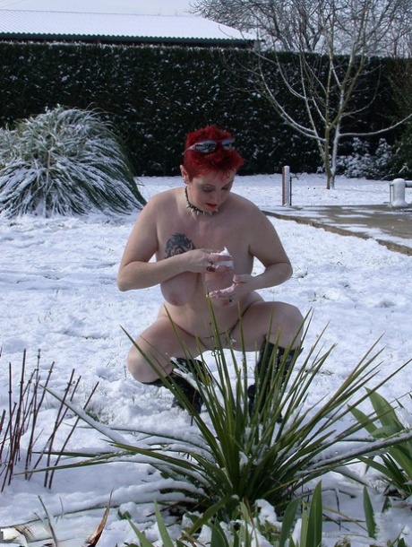 The snowy scene involves MaryBitch, a busy and adult redhead, cleaning up her hair and engaging in masturbation.