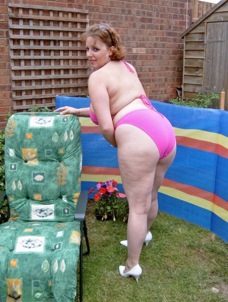 Curvy Claire, a brave and strong woman with a big chest, removes her bikini from the backyard to engage in finger-pointing.