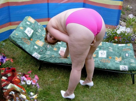 The hysterical and overweight Curvy Claire strips off in the backyard to have a good time.