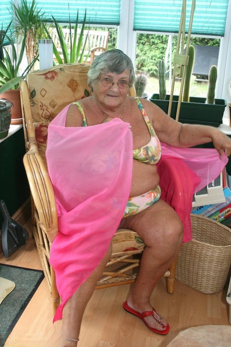 A horny old lady wearing glasses disrobes and exposes her large tits and antlers.
